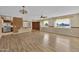 Open living area with hardwood floors, kitchen access, and large windows at 11034 W Alabama Ave, Sun City, AZ 85351