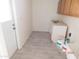 Bright laundry room with tile floor, cabinets, and exterior access at 1133 E 11Th St, Casa Grande, AZ 85122