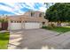 Two-story house with a three-car garage and well-maintained landscaping at 1231 N Crystal Shores Dr, Gilbert, AZ 85234