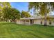 Backyard view showing a patio, lawn, and mature trees at 15446 N Lakeforest Dr, Sun City, AZ 85351