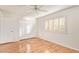 Bright bedroom with wood floors, double closets, and window shutters at 15446 N Lakeforest Dr, Sun City, AZ 85351