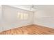 Bedroom with wood flooring and window with shutters at 15446 N Lakeforest Dr, Sun City, AZ 85351