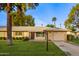 Single-story home with a landscaped lawn and attached garage at 15446 N Lakeforest Dr, Sun City, AZ 85351