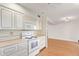 White kitchen with electric range and microwave at 15446 N Lakeforest Dr, Sun City, AZ 85351