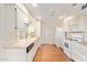 Open kitchen with white cabinets and laminate flooring at 15446 N Lakeforest Dr, Sun City, AZ 85351