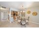 Dining area with glass-top table and four chairs, open to kitchen at 16655 E Saguaro Blvd # 116, Fountain Hills, AZ 85268