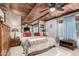 Spacious main bedroom with wood-beamed ceiling and en-suite bathroom at 1708 N Parsell Cir, Mesa, AZ 85203