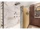 Elegant bathroom with marble shower and dark wood cabinets at 20811 E Excelsior Ave, Queen Creek, AZ 85142