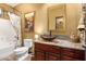 Bathroom with granite vanity, large mirror, and decorative artwork at 20811 E Excelsior Ave, Queen Creek, AZ 85142