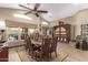 Bright dining room with a large table, chairs, cabinet, and view of backyard at 20811 E Excelsior Ave, Queen Creek, AZ 85142