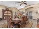 Spacious dining area featuring a dark wood table, matching chairs, and an ornate cabinet at 20811 E Excelsior Ave, Queen Creek, AZ 85142