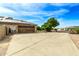 Long driveway leading to a house with a large garage and solar panels at 20811 E Excelsior Ave, Queen Creek, AZ 85142