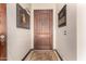Interior entryway with wood door and decorative wall hangings at 20811 E Excelsior Ave, Queen Creek, AZ 85142