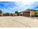 Large garage with double doors, solar panels, and gated driveway at 20811 E Excelsior Ave, Queen Creek, AZ 85142