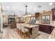Open kitchen with granite island and dark wood cabinetry at 20811 E Excelsior Ave, Queen Creek, AZ 85142