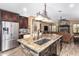 Island kitchen with granite countertops and stainless steel appliances at 20811 E Excelsior Ave, Queen Creek, AZ 85142
