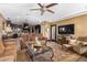 Open living area with kitchen, TV and ample seating at 20811 E Excelsior Ave, Queen Creek, AZ 85142