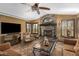 Spacious living room featuring a stone fireplace and comfy seating at 20811 E Excelsior Ave, Queen Creek, AZ 85142