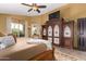 Spacious main bedroom with a king-size bed, large armoire, and window seat at 20811 E Excelsior Ave, Queen Creek, AZ 85142