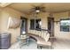 Relaxing patio with curved seating and glass top table at 20811 E Excelsior Ave, Queen Creek, AZ 85142