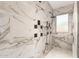 Spa-like shower with marble tile and multiple shower heads at 20811 E Excelsior Ave, Queen Creek, AZ 85142
