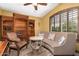 Cozy sitting area featuring a curved sofa, wooden chair, and built-in shelving at 20811 E Excelsior Ave, Queen Creek, AZ 85142