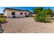Exterior view of backyard with desert landscaping, shrubs, and view of the home's exterior at 2233 N Middlecoff Dr, Mesa, AZ 85215