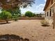 Spacious backyard features desert landscaping for low maintenance and a clean, contemporary aesthetic at 2233 N Middlecoff Dr, Mesa, AZ 85215