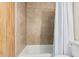 Bathroom featuring a tiled wall above the bathtub and a shower curtain, showcasing a clean and modern design at 2233 N Middlecoff Dr, Mesa, AZ 85215