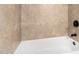 Bathroom featuring a tiled wall above the bathtub, showcasing a clean and modern design at 2233 N Middlecoff Dr, Mesa, AZ 85215