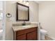 Bathroom featuring granite counter, dark wooden vanity and bronze fixtures at 2233 N Middlecoff Dr, Mesa, AZ 85215