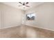 Bedroom featuring a window, tile flooring, and a ceiling fan, creating a functional space at 2233 N Middlecoff Dr, Mesa, AZ 85215
