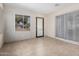 Bright room with tile floors, a window, and sliding door, ideal for an office or den at 2233 N Middlecoff Dr, Mesa, AZ 85215