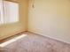Bright bedroom with neutral carpet, a window with blinds, and base molding at 2233 N Middlecoff Dr, Mesa, AZ 85215
