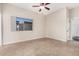 Bedroom featuring a window, tile flooring, and a ceiling fan, creating a functional space at 2233 N Middlecoff Dr, Mesa, AZ 85215