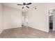 Bedroom featuring a window, tile flooring, and a ceiling fan, creating a functional space at 2233 N Middlecoff Dr, Mesa, AZ 85215