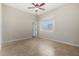 Bright bedroom featuring neutral walls, tile floors, a ceiling fan, and a window offering natural light at 2233 N Middlecoff Dr, Mesa, AZ 85215