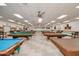 Large billiard room displaying multiple pool tables with overhead lighting at 2233 N Middlecoff Dr, Mesa, AZ 85215