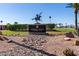 Apache Wells Country Club sign featuring a Native American statue on a well-manicured green lawn at 2233 N Middlecoff Dr, Mesa, AZ 85215
