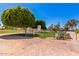 Gated dog park with grassy areas, shade structures, and mature trees, ideal for community pet owners at 2233 N Middlecoff Dr, Mesa, AZ 85215