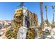 Striking water feature and sign at the entrance of Apache Wells at 2233 N Middlecoff Dr, Mesa, AZ 85215