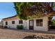 Back exterior of home with gravel landscaping and mature trees for shade at 2233 N Middlecoff Dr, Mesa, AZ 85215