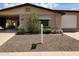 Charming home featuring a well-maintained front yard with desert landscaping and a covered carport at 2233 N Middlecoff Dr, Mesa, AZ 85215