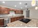 Stylish kitchen features a center island with cooktop, granite countertops, and stainless steel appliances at 2233 N Middlecoff Dr, Mesa, AZ 85215