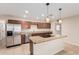 Kitchen features stainless steel appliances, granite countertops, and center island at 2233 N Middlecoff Dr, Mesa, AZ 85215