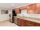 Updated kitchen features stainless steel appliances, a spacious granite counter, and ample storage at 2233 N Middlecoff Dr, Mesa, AZ 85215