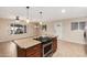 Open-concept kitchen with center island, granite counters, and modern appliances at 2233 N Middlecoff Dr, Mesa, AZ 85215
