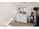 Functional laundry room with updated machines, tile flooring and bright natural light at 2233 N Middlecoff Dr, Mesa, AZ 85215