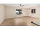 Spacious living room featuring tile flooring, abundant natural light, and a modern ceiling fan at 2233 N Middlecoff Dr, Mesa, AZ 85215