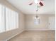 Bright living room featuring tile floors, a ceiling fan, and large windows at 2233 N Middlecoff Dr, Mesa, AZ 85215